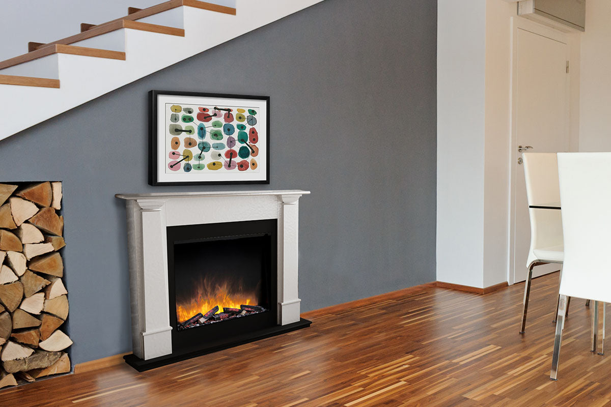 Living room with electric fireplace, wooden logs, and framed artwork on a gray wall.
